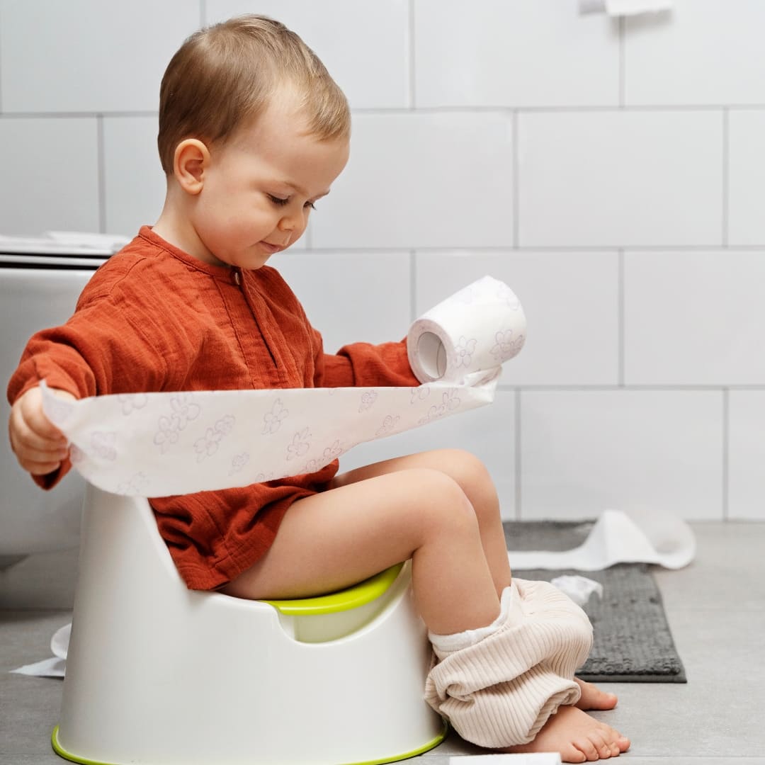 Jeune enfant assis sur un pot pendant l’apprentissage de la propreté